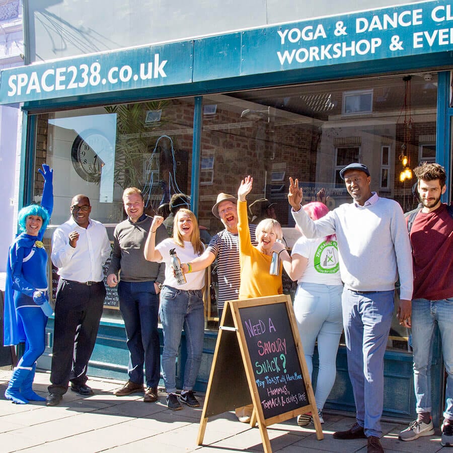 sq group volunteers Stapleton Road on National Refill Day, people with bottles outside cafe