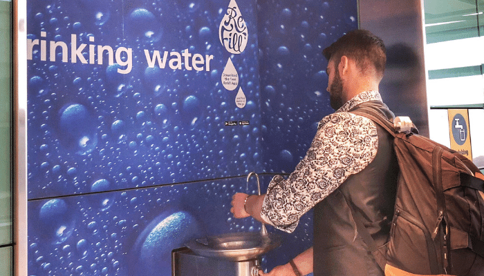 Man filling bottle at fountain